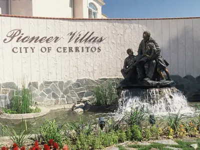 Pioneer Villas wall sign and fountain with sculpture